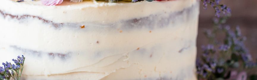A slice of layered cake with cream and chocolate decorations.