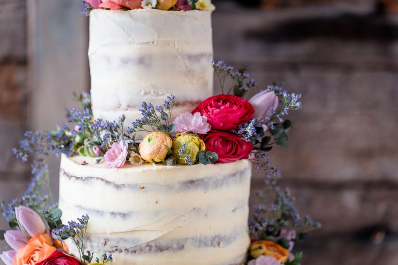 Three tier cream chocolate wedding cake with pretty flowers