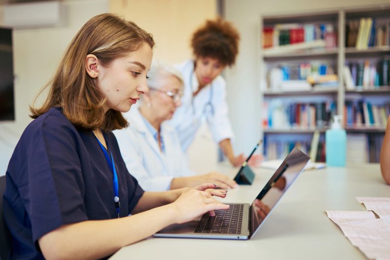 Healthcare professionals collaborating in a modern hospital setting, focusing on teamwork and patient care