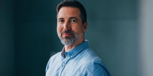 Portrait of a confident middle-aged man with a beard.