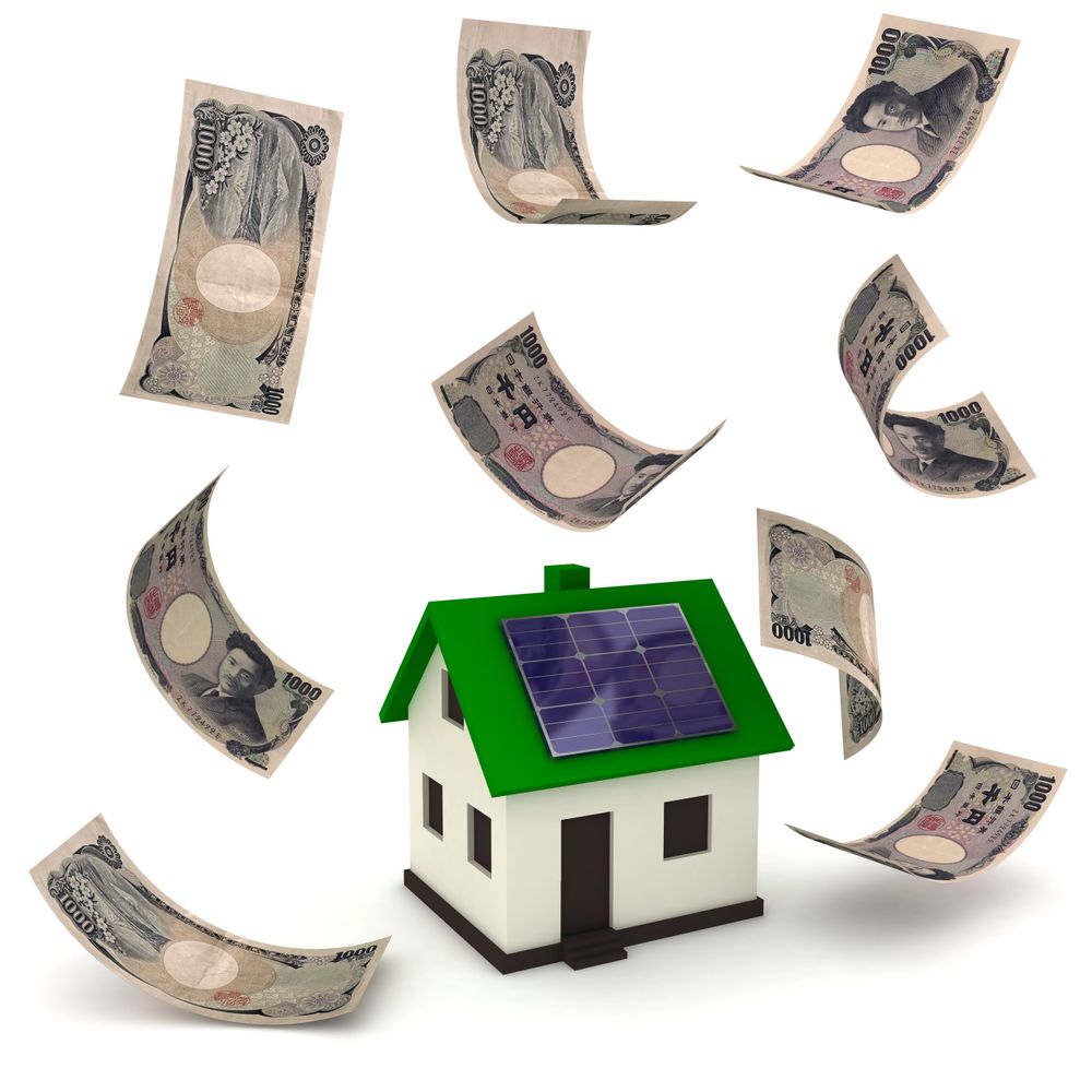 Model house with solar panel surrounded by flying Japanese yen bills.