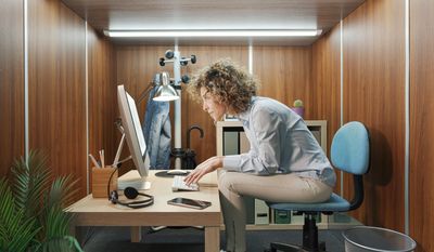 Woman slouches over her computer with bad posture