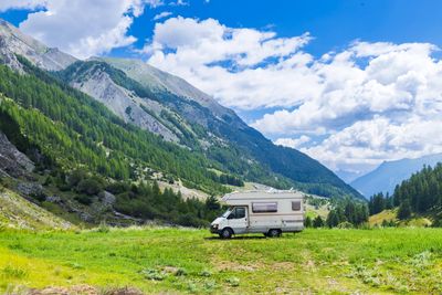 RV camping in front of scenic mountains.