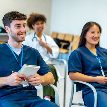 Medical students attentively listening in a classroom setting.