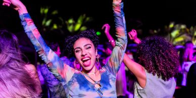 Young woman dancing joyfully at a party.