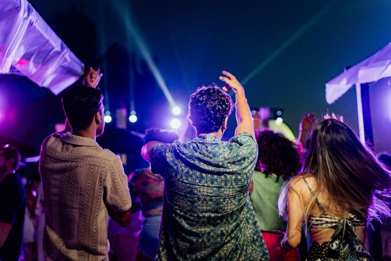 Young friends dancing during party outdoors