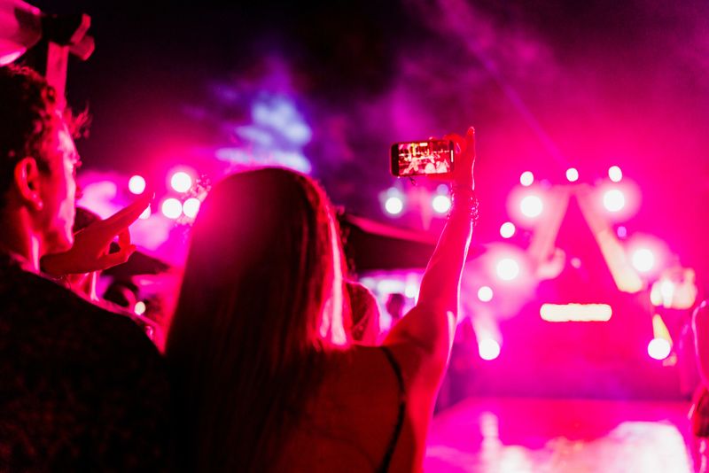Young couple taking a selfie during party outdoors