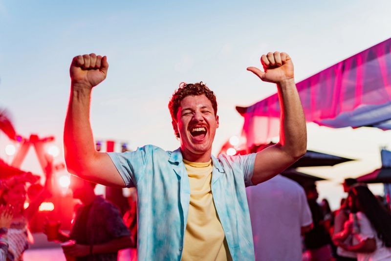 Portrait of young man dancing on party outdoors
