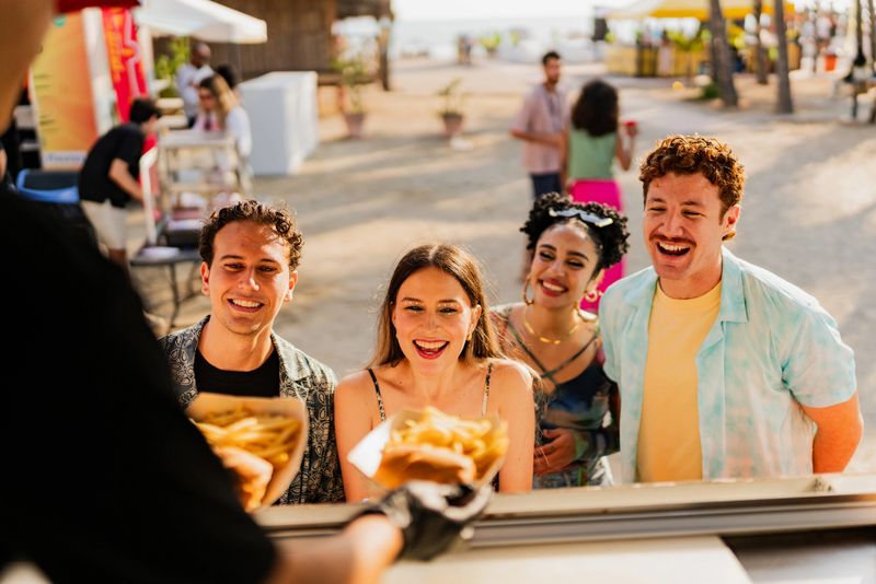 Young friends buying snacks outdoors