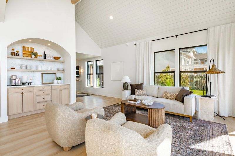 Interior rooms of an ocean front  home with floor to ceiling windows vaulted ceiling elegant spacious blue sky waterfront modern kitchen dining room entry foyer bedroom small home office area post and beam glass railing staircase loft bathrooms are white with marble granite and glass shower free standing bathtub modern appliances