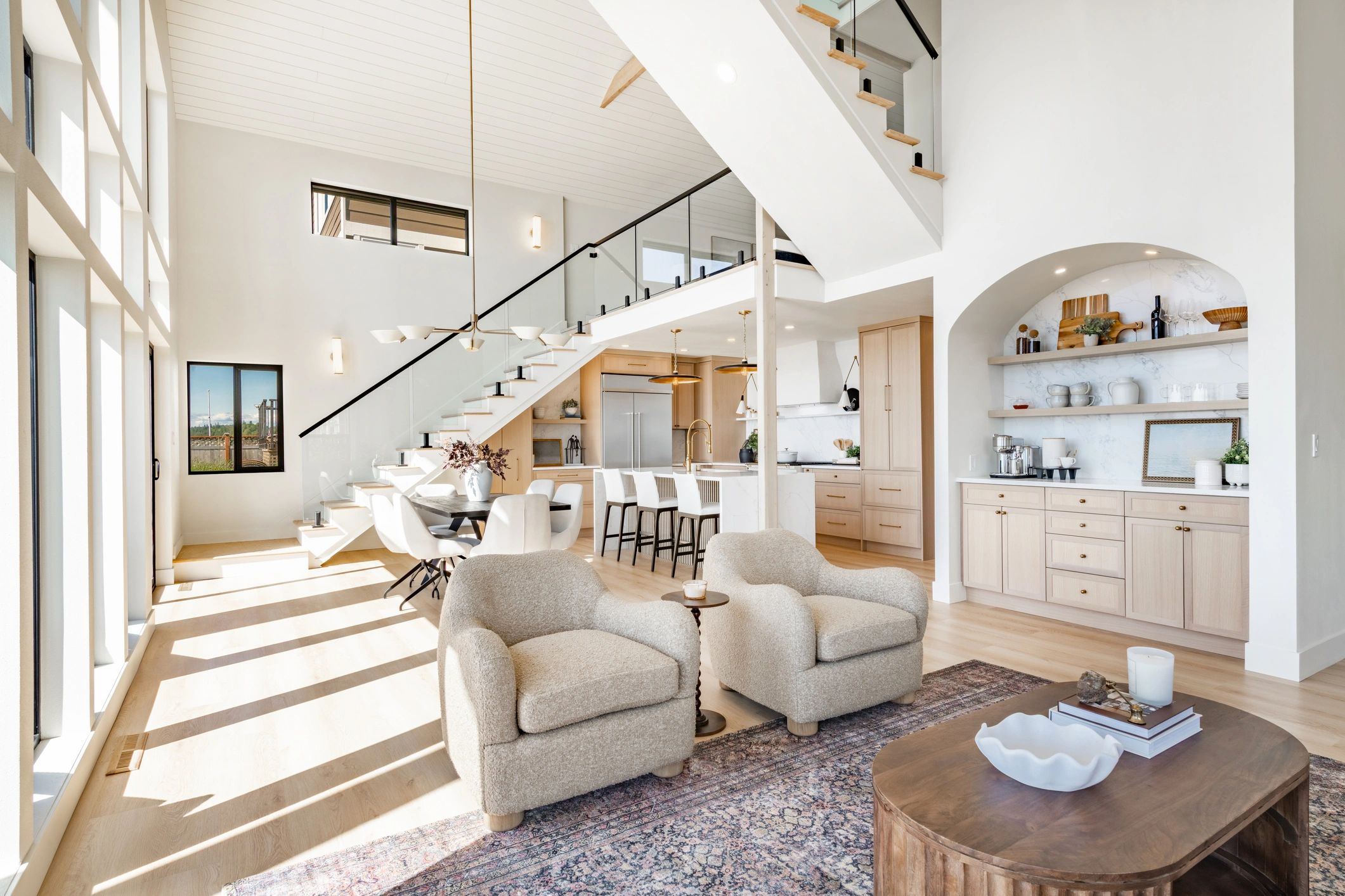 Bright modern living area with high ceilings and cozy seating.
