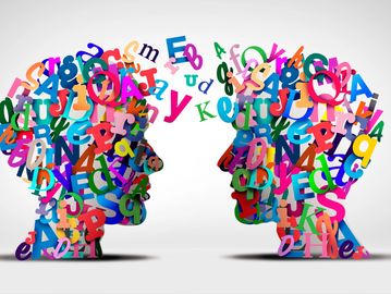 Two human profiles made of colorful letters facing each other.