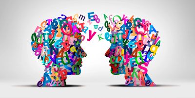 Two colorful human profiles made of letters facing each other.