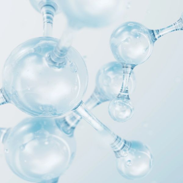 Laboratory glassware with chemical formulas and molecular models in the background.