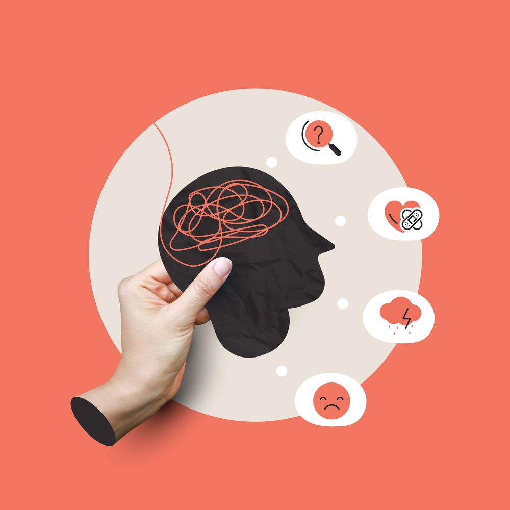 Hand holding a head silhouette with tangled lines, symbolizing mental confusion and emotions.