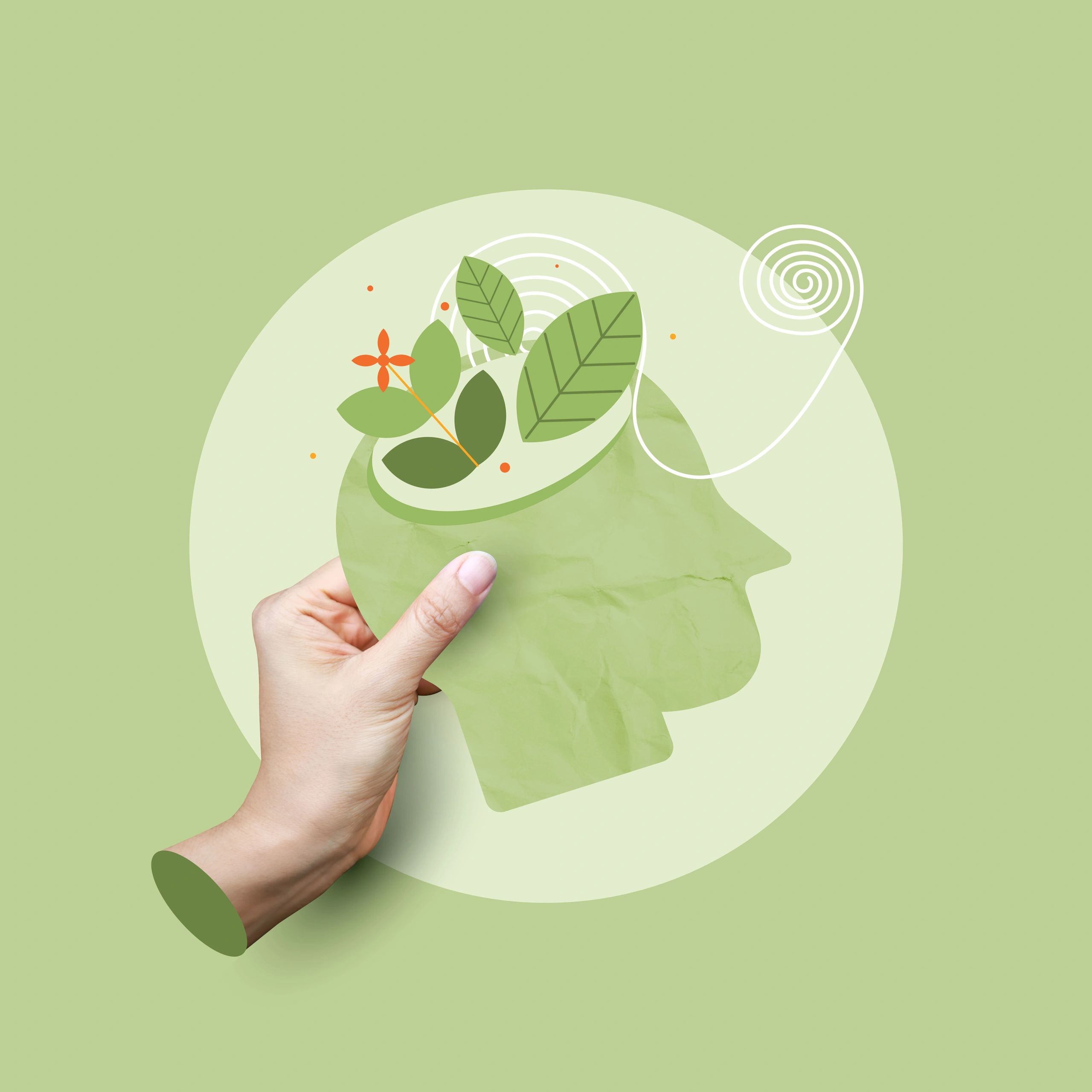 Hand holding a green envelope with leaf and flower designs on a light green background.
