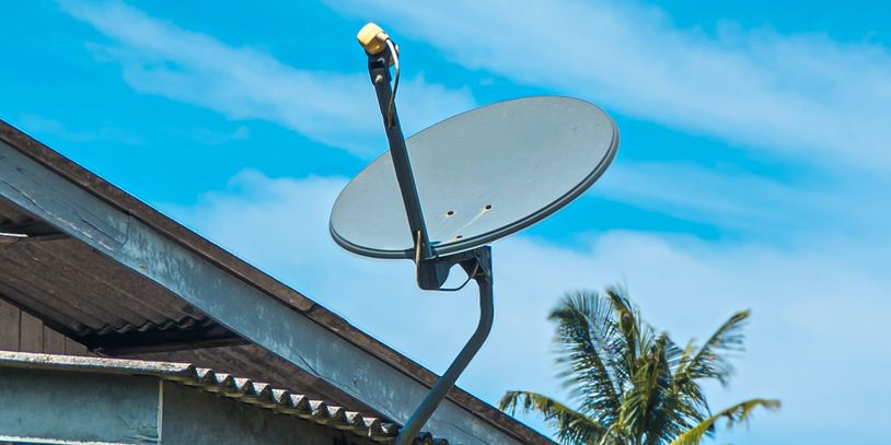 Old residential satellite dish mounted
on a roof and ready for removal by
DGT Junk Removal in San Ta