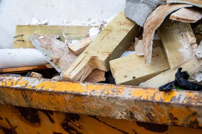 A dumpster filled with construction debris and broken wood pieces.construction waste clearance
London waste removal
waste disposal services