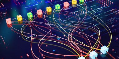 Colorful cubes connected by glowing lines on a digital circuit board.