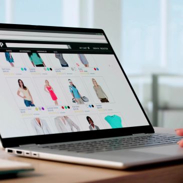 Online shopping for women's clothing on a laptop.