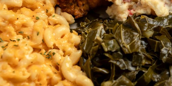 Macaroni and cheese with cooked greens.