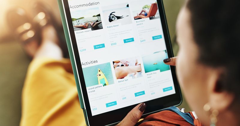 Woman, hands and sofa with tablet screen for holiday, accommodation or travel website at home. Closeup, female person or user with technology display or app for online booking, activities or deal