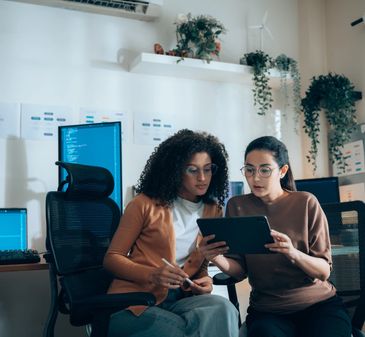 Two diverse women working together in an office.