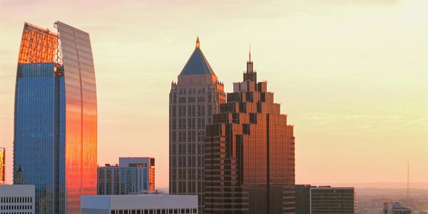 Sunset lighting on city skyscrapers.