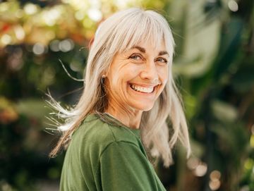 happy woman smiling as she is on hormone replacement therapy and functional medicine with Pathway