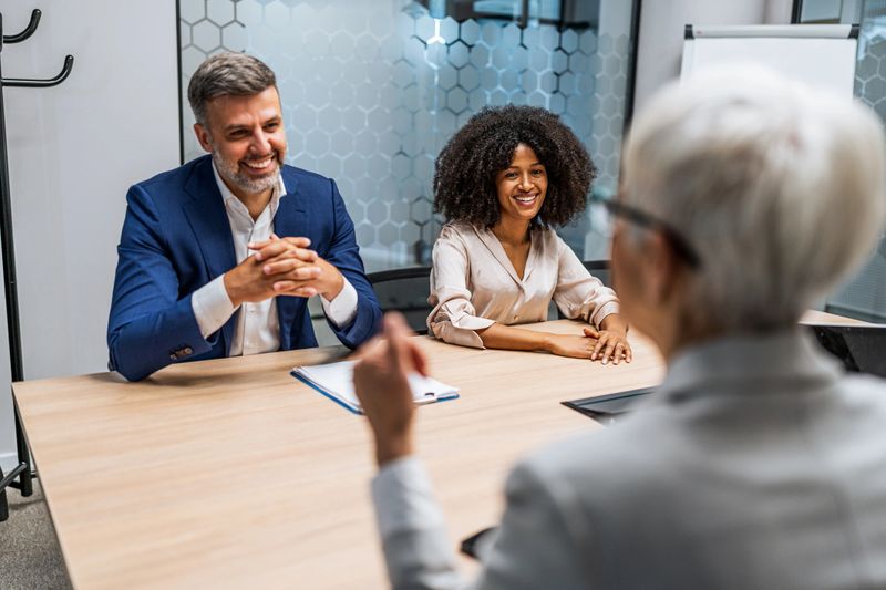 Multi-ethnic business team interviewing a mature businesswoman for a job opportunity in a modern office