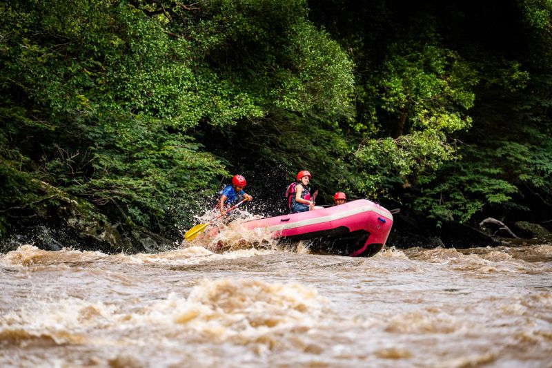 Friends rafting on a river