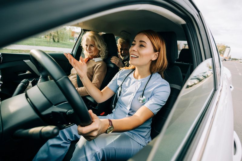 Caregiver driving elderly patient to medical appointment