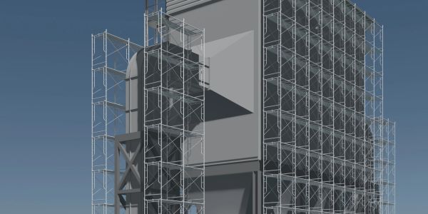 Large building under construction with extensive scaffolding against a clear sky.