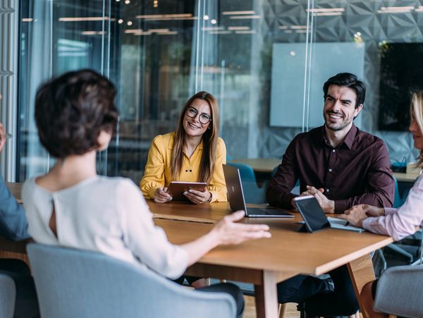 corporate event planner and professional colleagues reviewing solutions