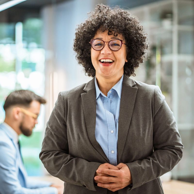 Portrait of smiling confident mature african american businesswoman leader looking at camera standing in office