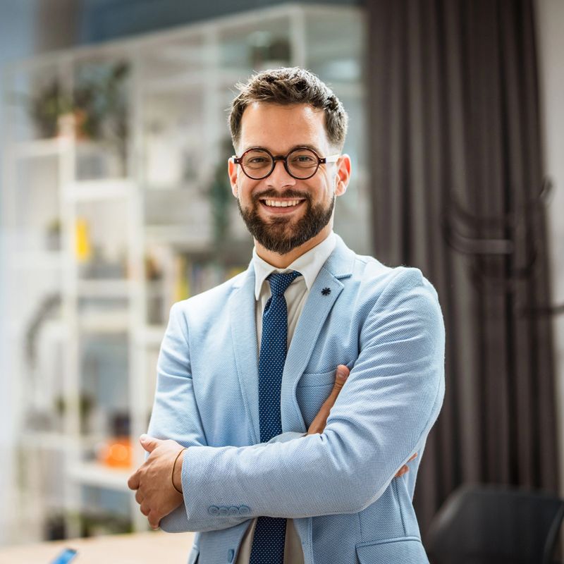 Portrait of a well-dressed caucasian businessman standing in office