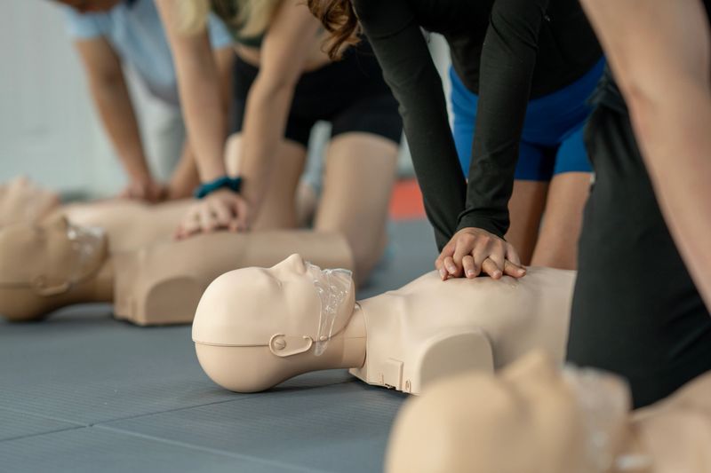 A group engaging in hands-on CPR and first aid training, focusing on skill development and safety.