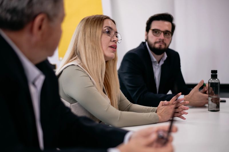 Colleagues participating in a serious meeting, showcasing professional collaboration and strategic thinking in a formal office setting.