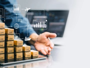 Stacked boxes on a tablet with logistics and supply chain icons floating above.