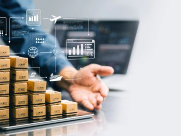Businessman analyzing logistics data with digital graphs and shipping icons.