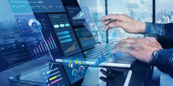Person analyzing digital marketing KPIs on a laptop with futuristic data interfaces.
