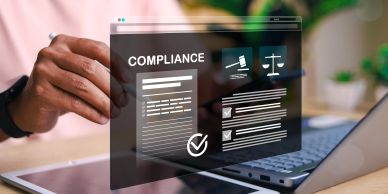A person interacting with a digital compliance interface on a laptop.