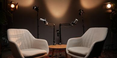 Podcast or interview setup with microphones and chairs.