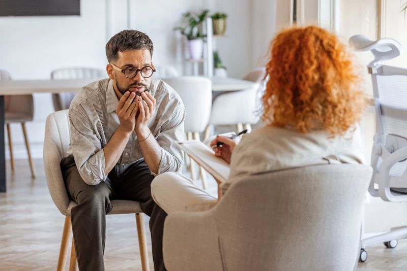 A counselor provides empathy and support during an in-depth therapy session with a client. The professional and caring environment enhances open dialogue, ensuring a positive approach to emotional well-being and mental health improvement.