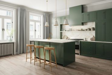 Modern kitchen with green cabinets and island.