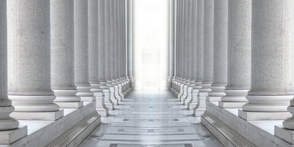Symmetrical row of classical stone columns forming a grand corridor.