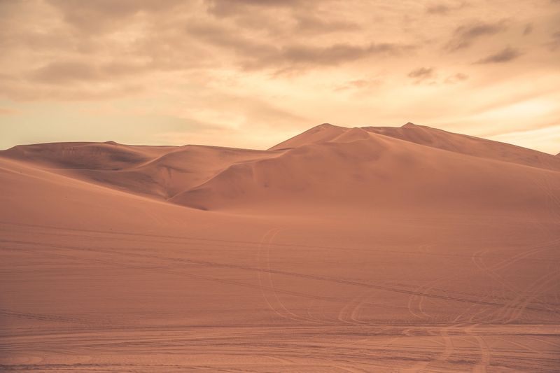 Ica desert landscape with smooth golden sand dunes near Huacachina, Peru.