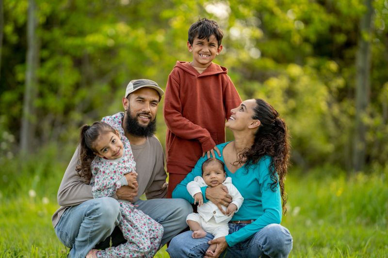 A joyful family posing together outside, capturing a special moment.