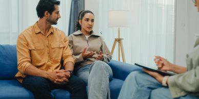 Couple discussing with a counselor in a therapy session.