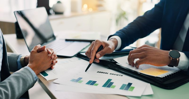 Business people reviewing investment documents